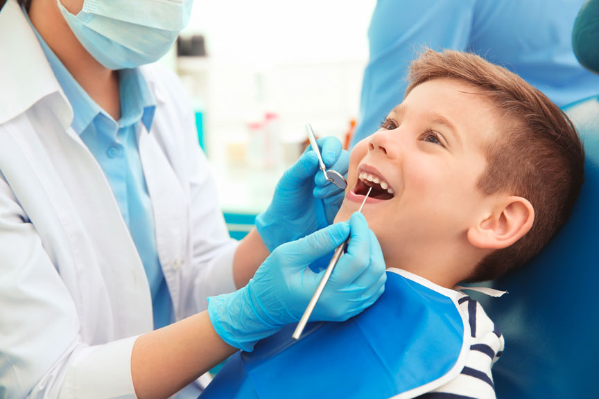 Dentist Performing Teeth Cleaning Procedure in Quincy & Norwell, MA
