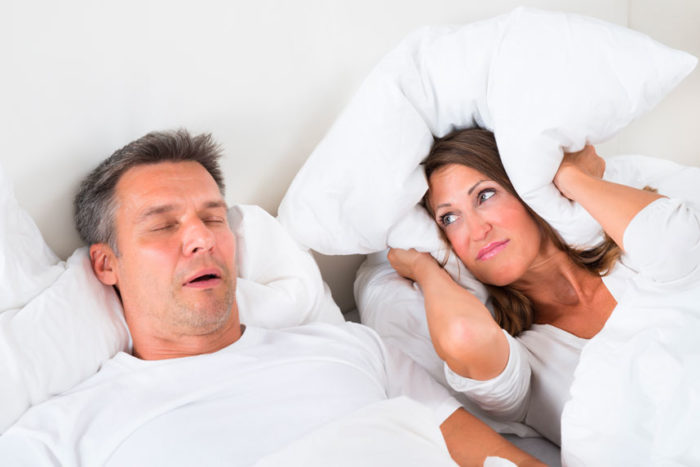 Individual Snoring in Sleep While Spouse Covers The Ears With a Pillow