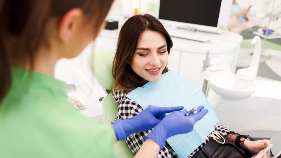 Dentist Showing Invisible Veener to Patient