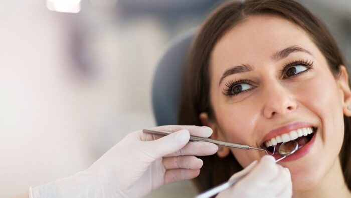 Patient Smiling While Having a Dental Filling Treatment
